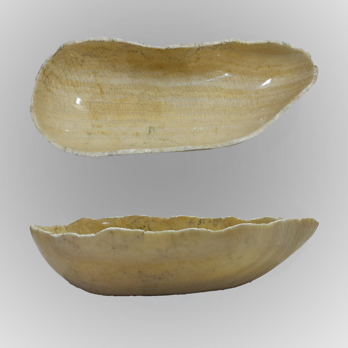 A free-form onyx bowl with a smooth, curved shape, beige