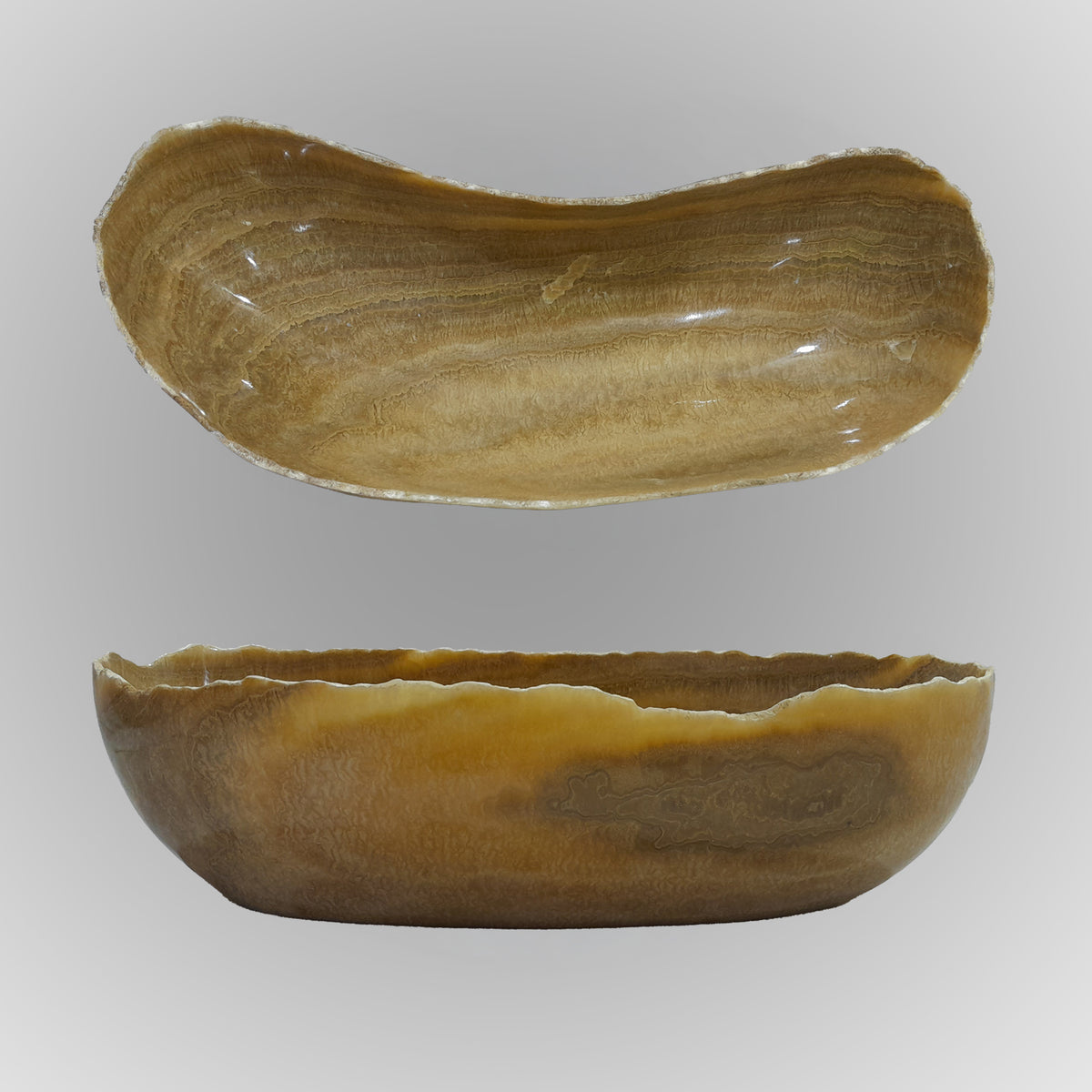 A free-form onyx bowl with a smooth, curved shape, brown and beige