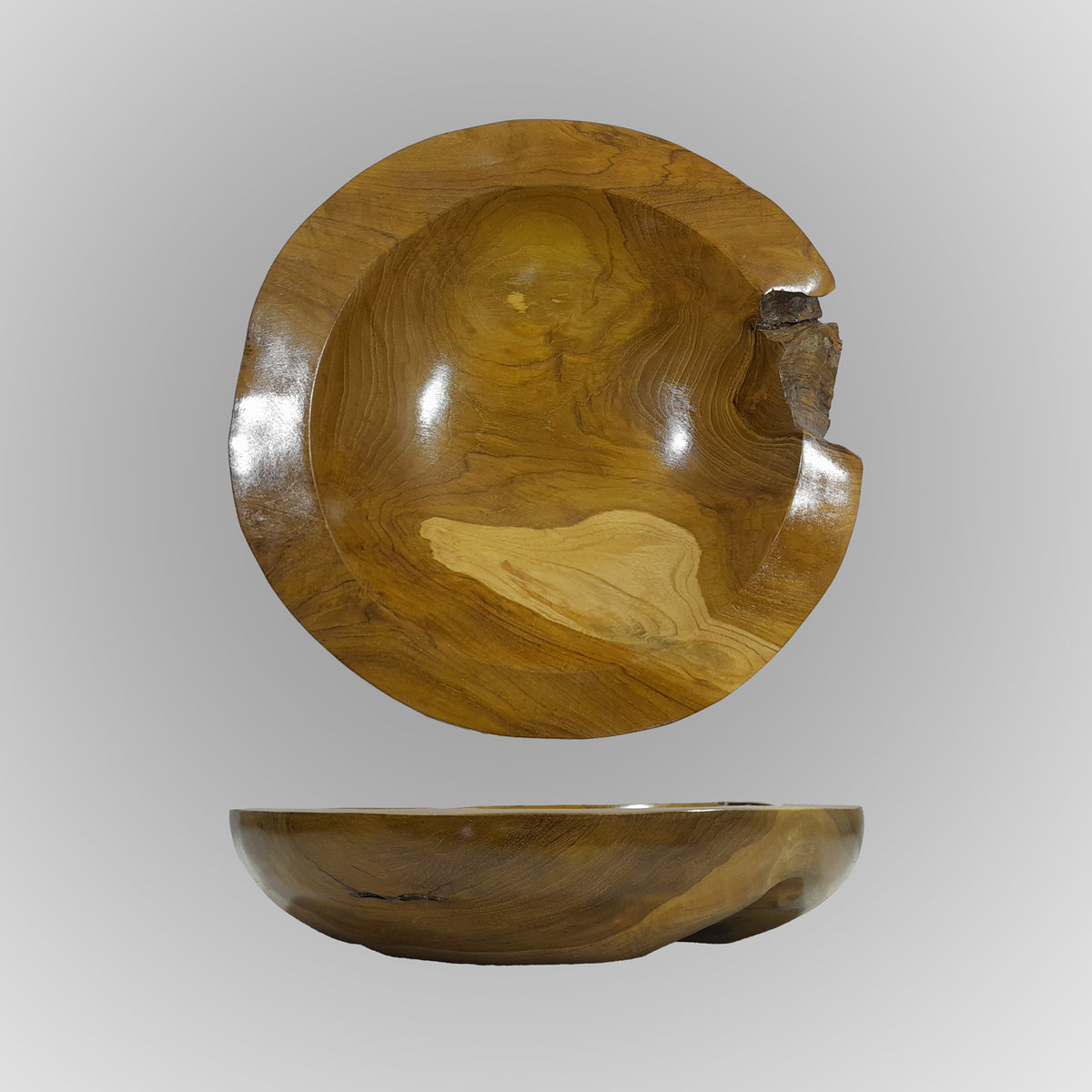A hand-carved teak wood bowl with a smooth finish, showing natural wood grain, is displayed on a gray background image 3 of 6
