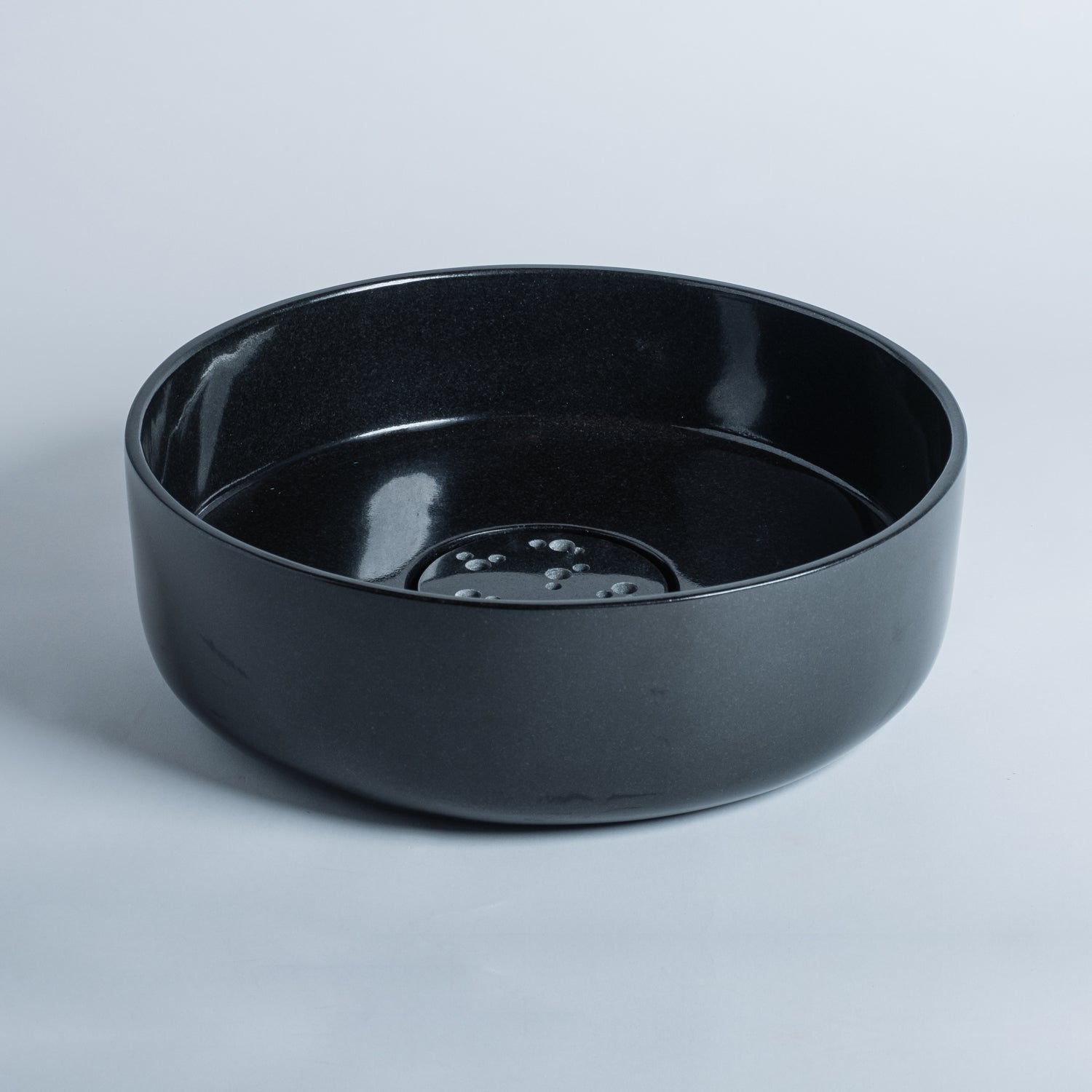 thin-walled vessel sink is carved from a solid block of black granite and finished to a high polish; Drain cover is included.
