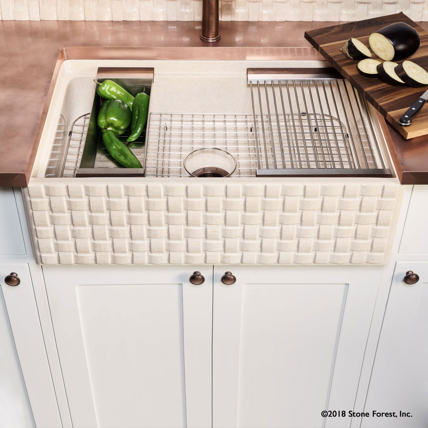 Work station farm house sink with basket weave carved on the apron.