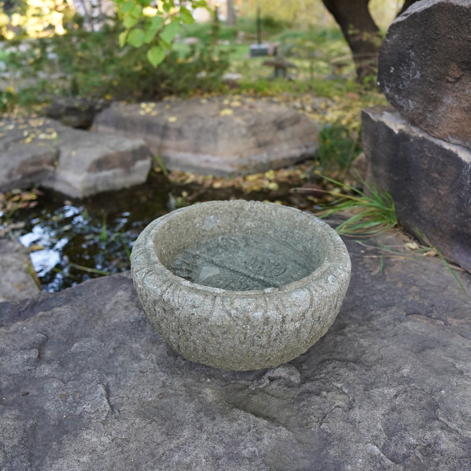 Lotus Basin is carved from Verde Basalt, featuring Buddha Feet details carved into the bottom of the basin.