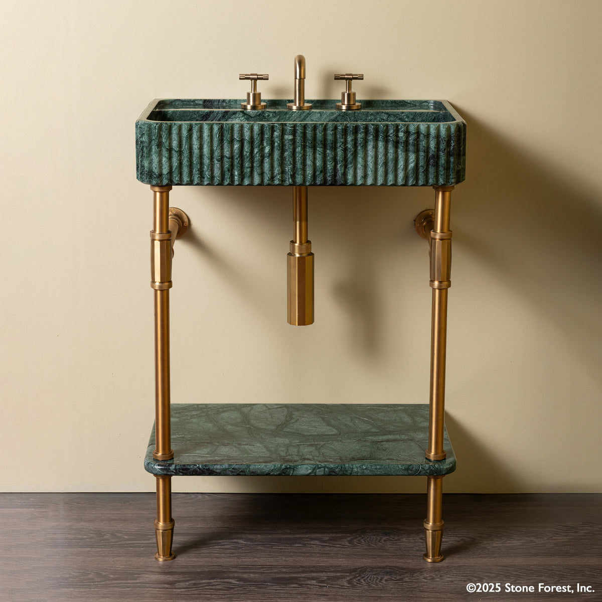A green marble sink with Aged Brass brass fittings and legs, paired with a lower shelf that is also in green marble. image 1 of 3