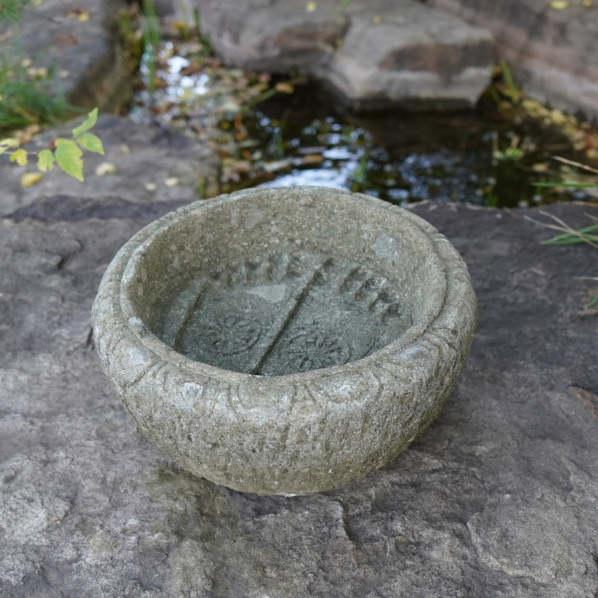 Lotus Basin is carved from Verde Basalt, featuring Buddha Feet details carved into the bottom of the basin. image 2 of 3