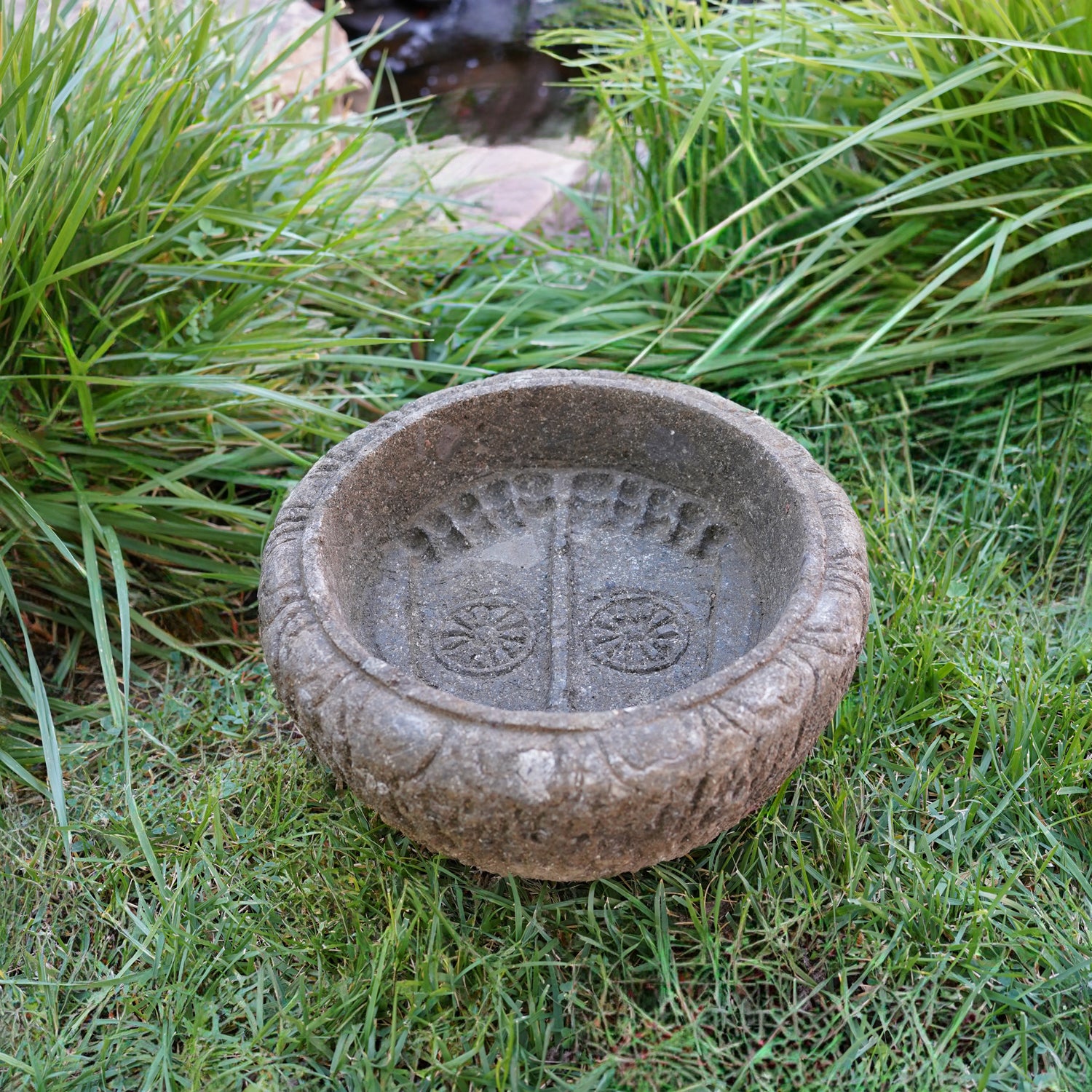 Lotus Basin is carved from Verde Basalt, featuring Buddha Feet details carved into the bottom of the basin.