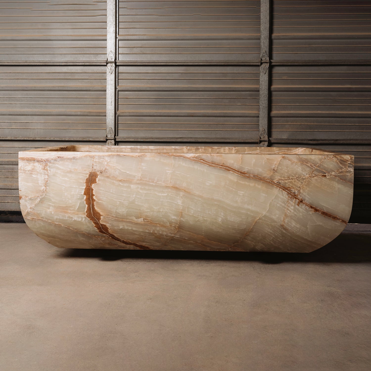 A large, rectangular onyx trough planter with multi-color patterns, displayed indoors.