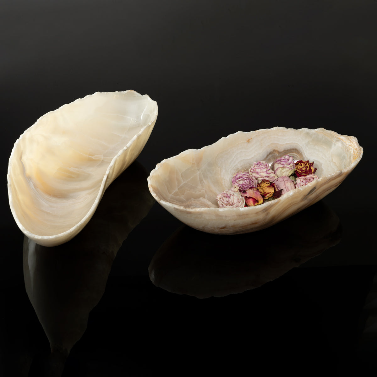 Two  free form onyx bowls with a smooth, curved shape, one is holding roses image 2 of 6