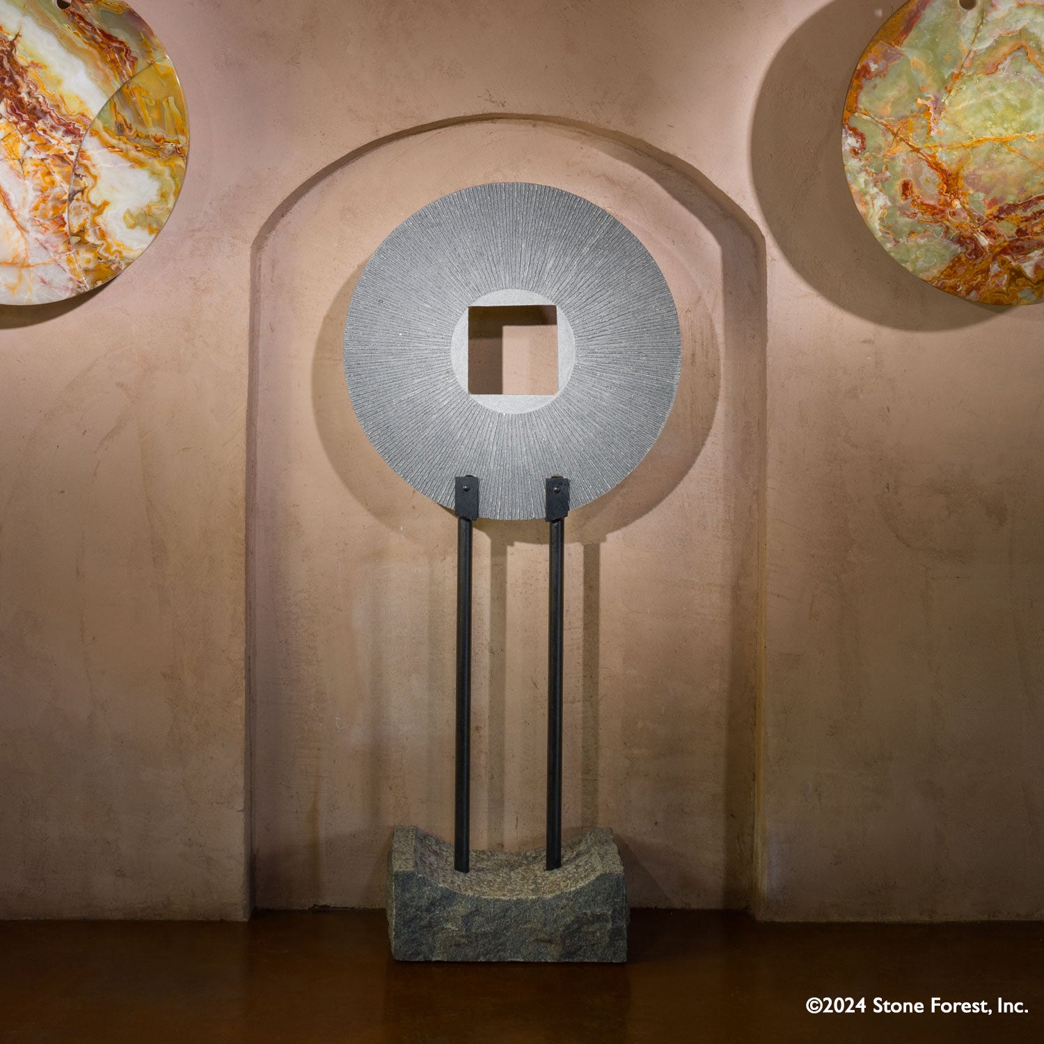 Gallery-worthy sculpture, ancient/contemporary. The hand-carved blue-gray granite pendant features a ribbed pattern on both surfaces and can be used indoors or outdoors, supported by an iron stand.