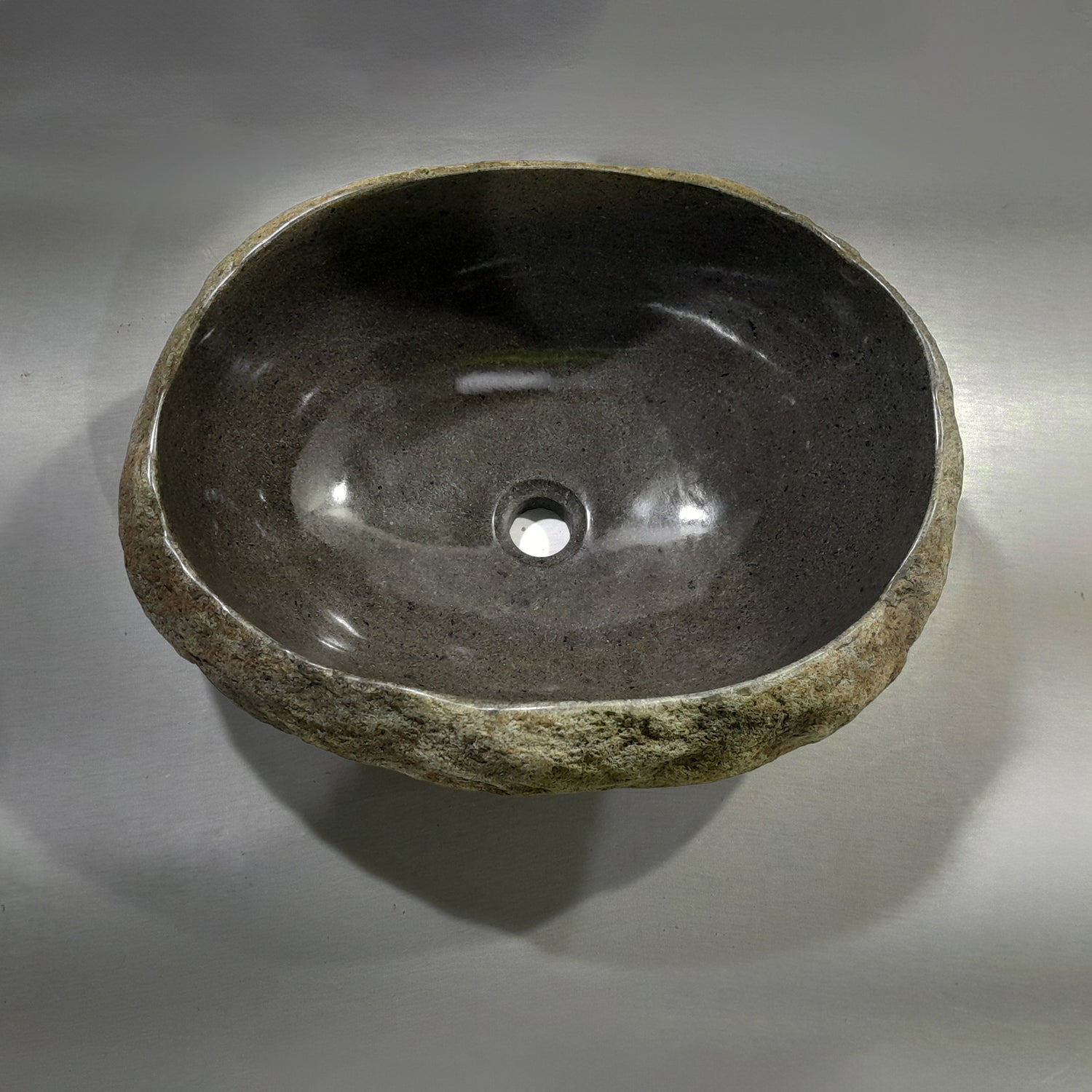 Natural stone sink on a gray background