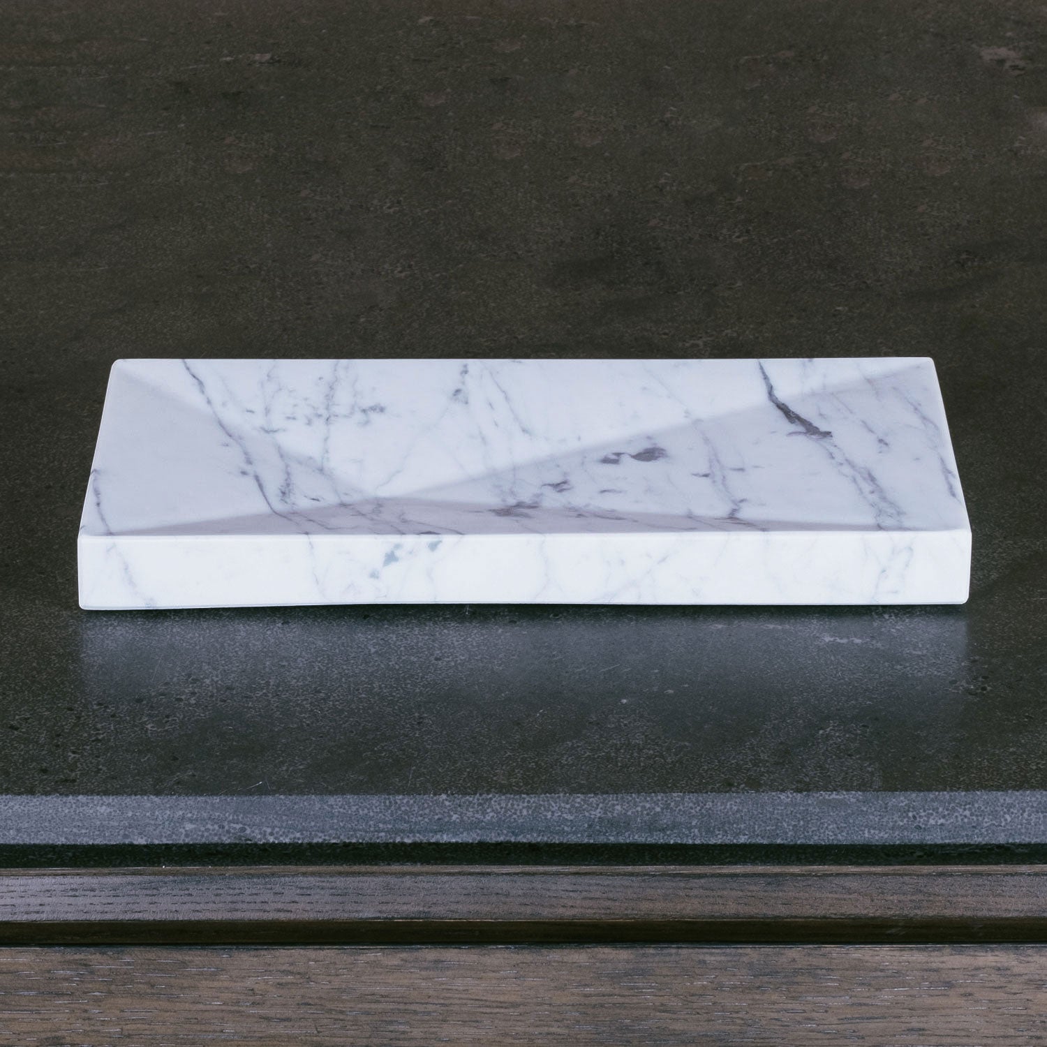 A rectangular Carrara marble bath tray with visible white and gray patterns characteristic of marble stone.