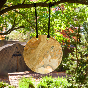 Gallery-worthy hanging sculptures carved from blocks of beige onyx with a convex surface and honed finish.  Installed using a suspension strap. image 1 of 2