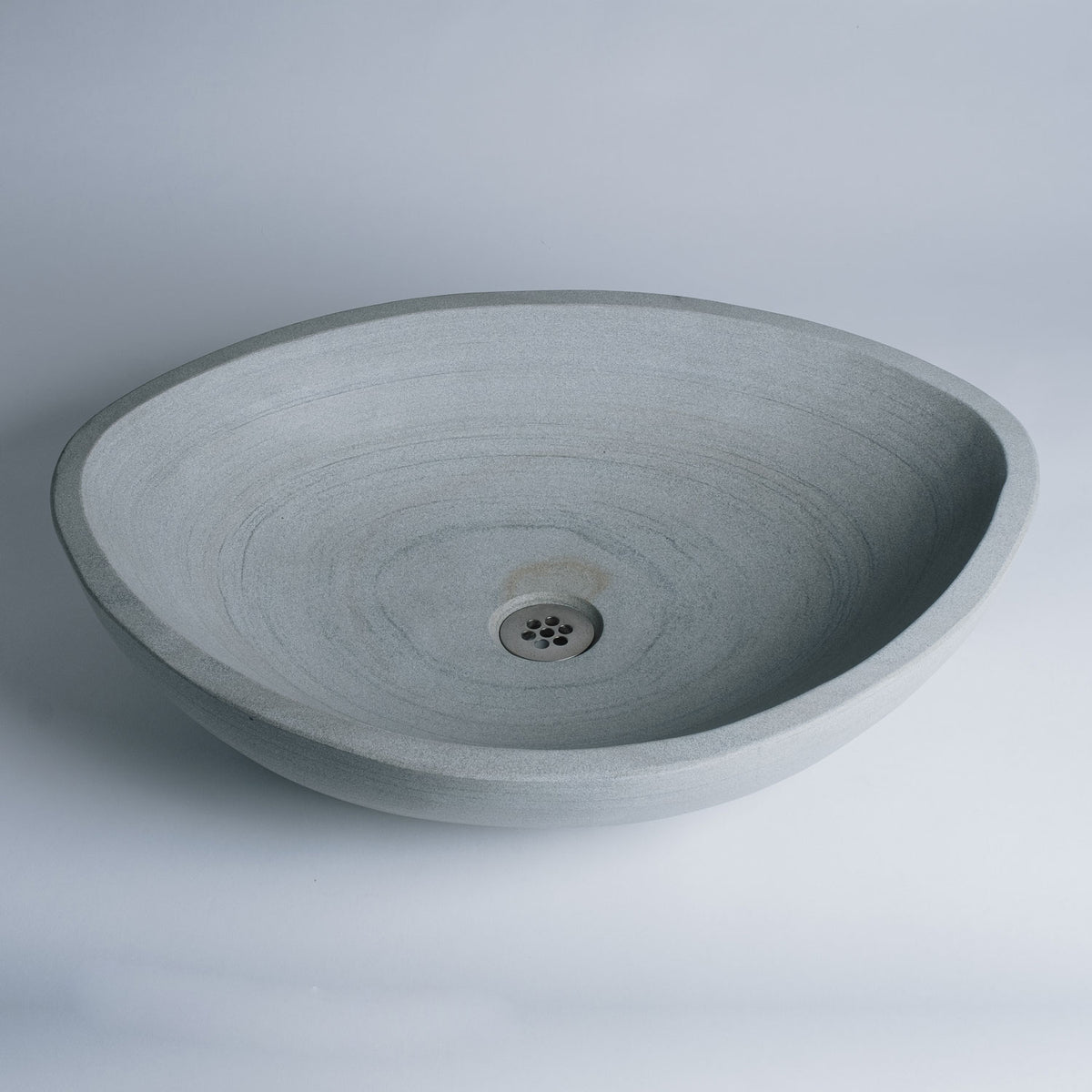 Akrotiri Vessel Sink is carved in grigio sandstone. This Akrotiri Vessel Sink is being sold as a second because of the naturally occurring brown spot next to the drain area. image 1 of 5