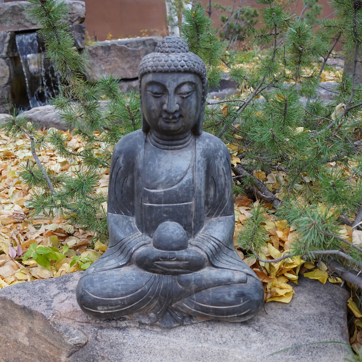 A hand-carved dark limestone Buddha statue seated  image 3 of 5