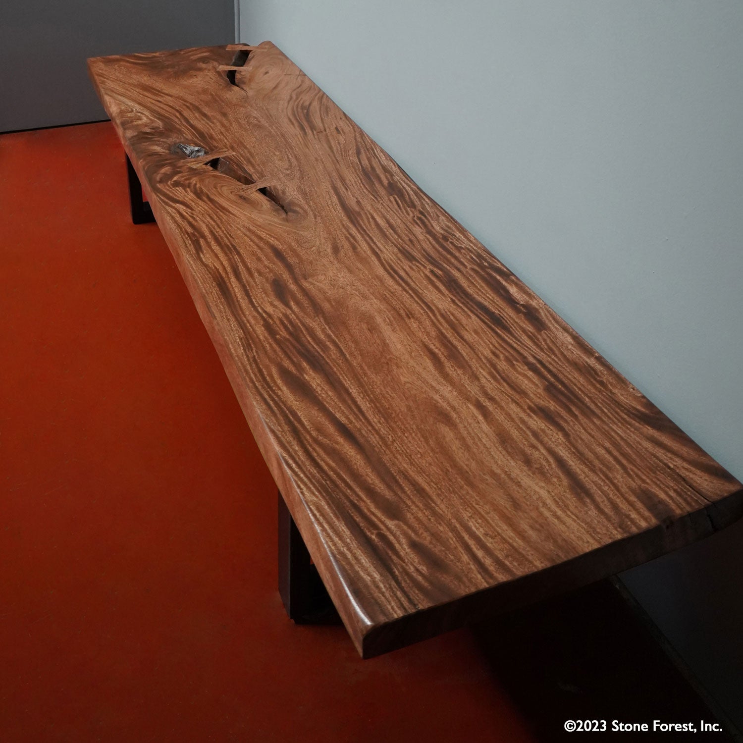 This massive wood bench is truly unique and is a one-of-a-kind piece. hand-made from a thick slab of Acacia hardwood supported by metal legs. Top view