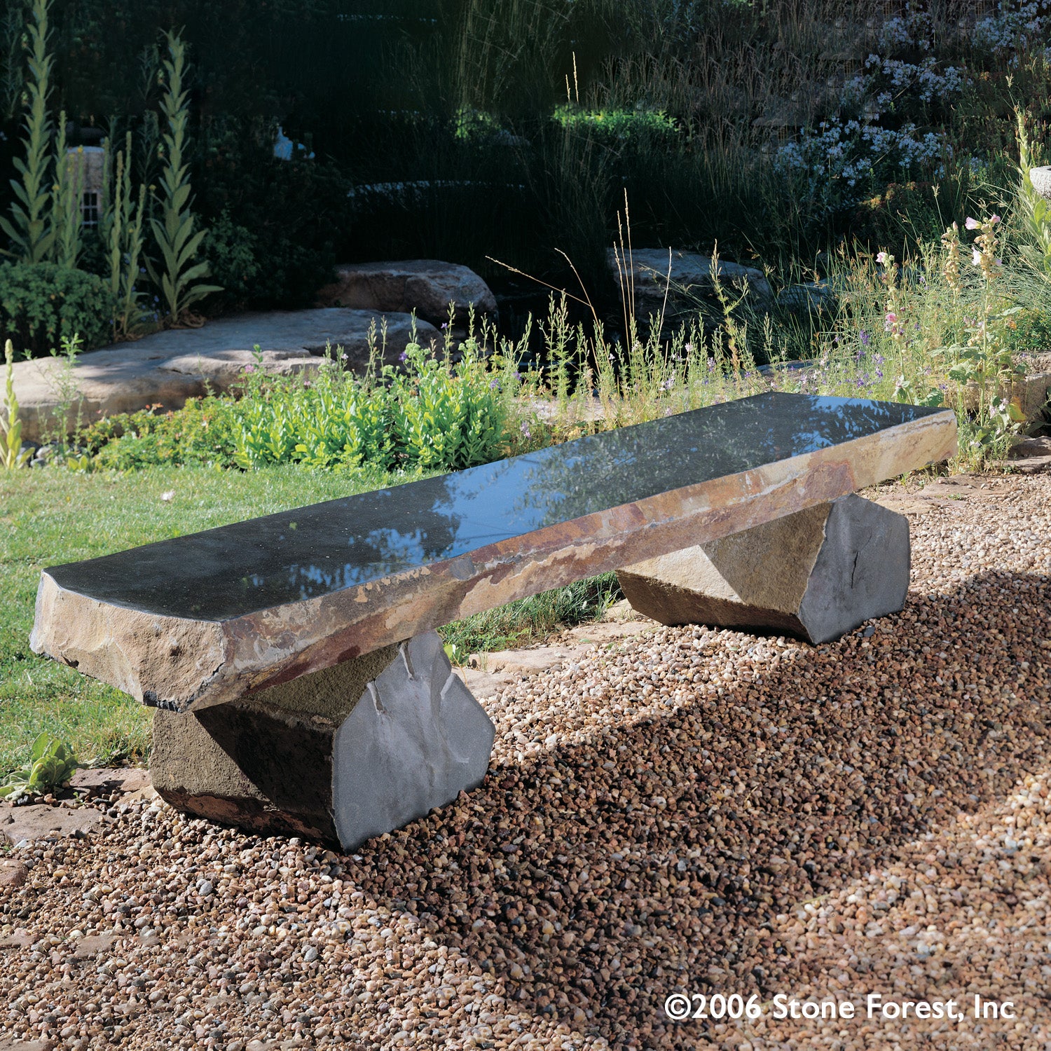Polished top basalt bench with naturally weathered sides and legs.