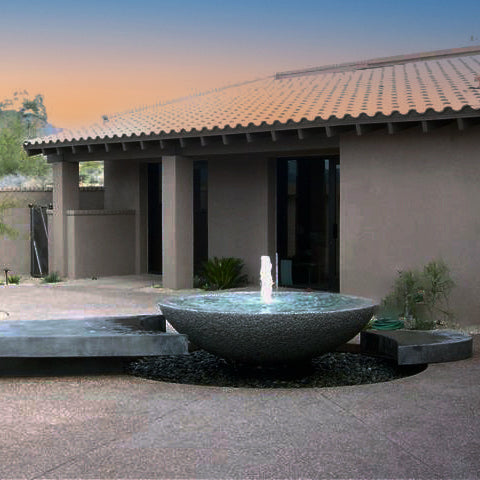 A contemporary style custom fountain with a large granite stone placed on a patio. image 1 of 1