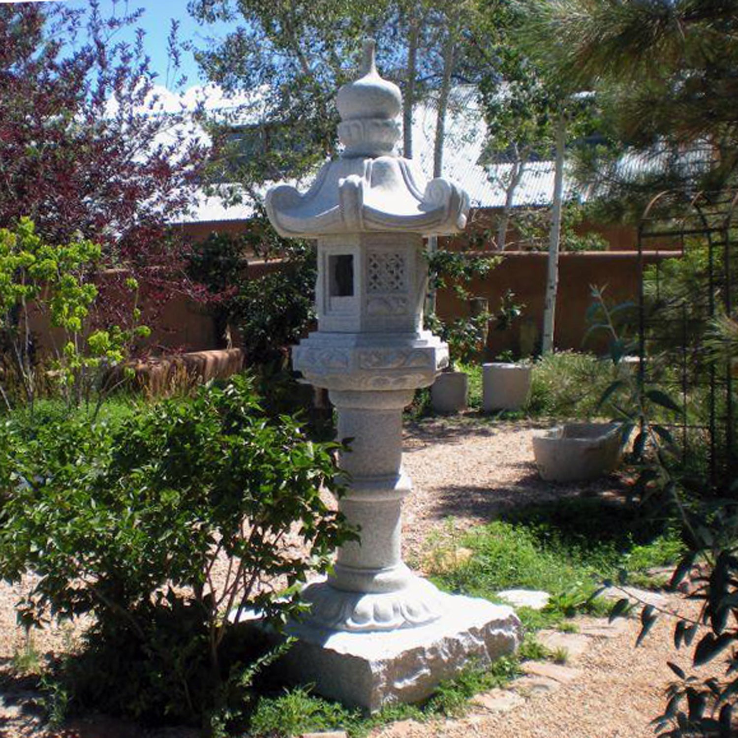 Stone Forest Kasuga-style lantern. This traditional Japanese Lantern is of the Tachi-gata-style or pedestal stone lanterns. Carved from black & white (salt & pepper) granite. 96"h