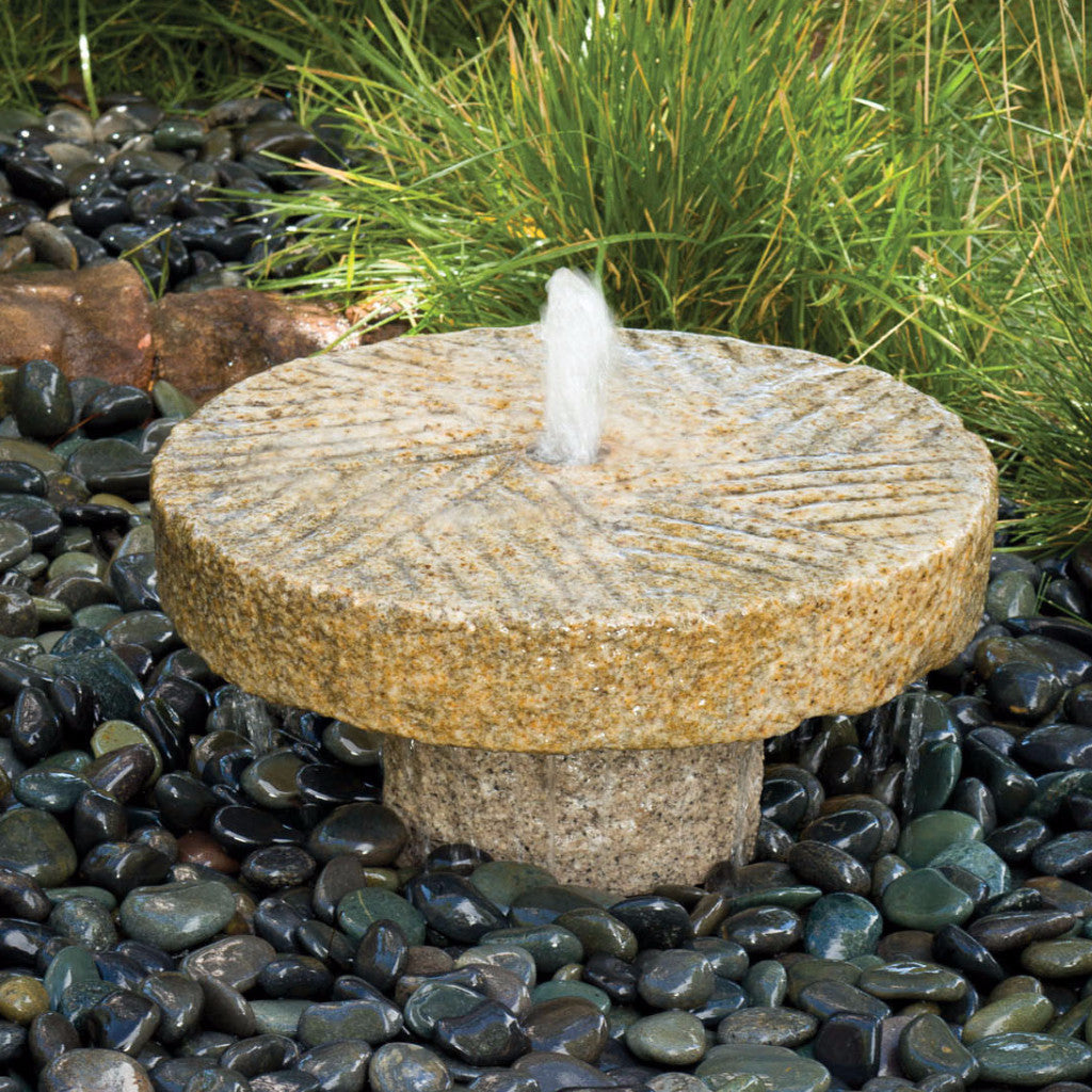 Stone Forest small antique millstone used as a garden fountain image 1 of 2