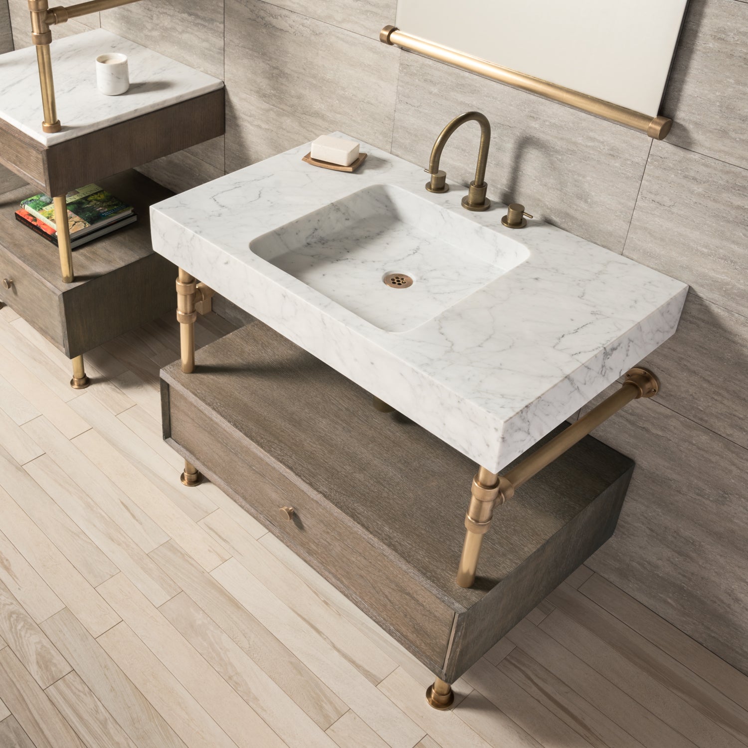 A Carrara marble bath sink on an Elemental Classic Drawer Vanity with an aged brass finish and wood elements.