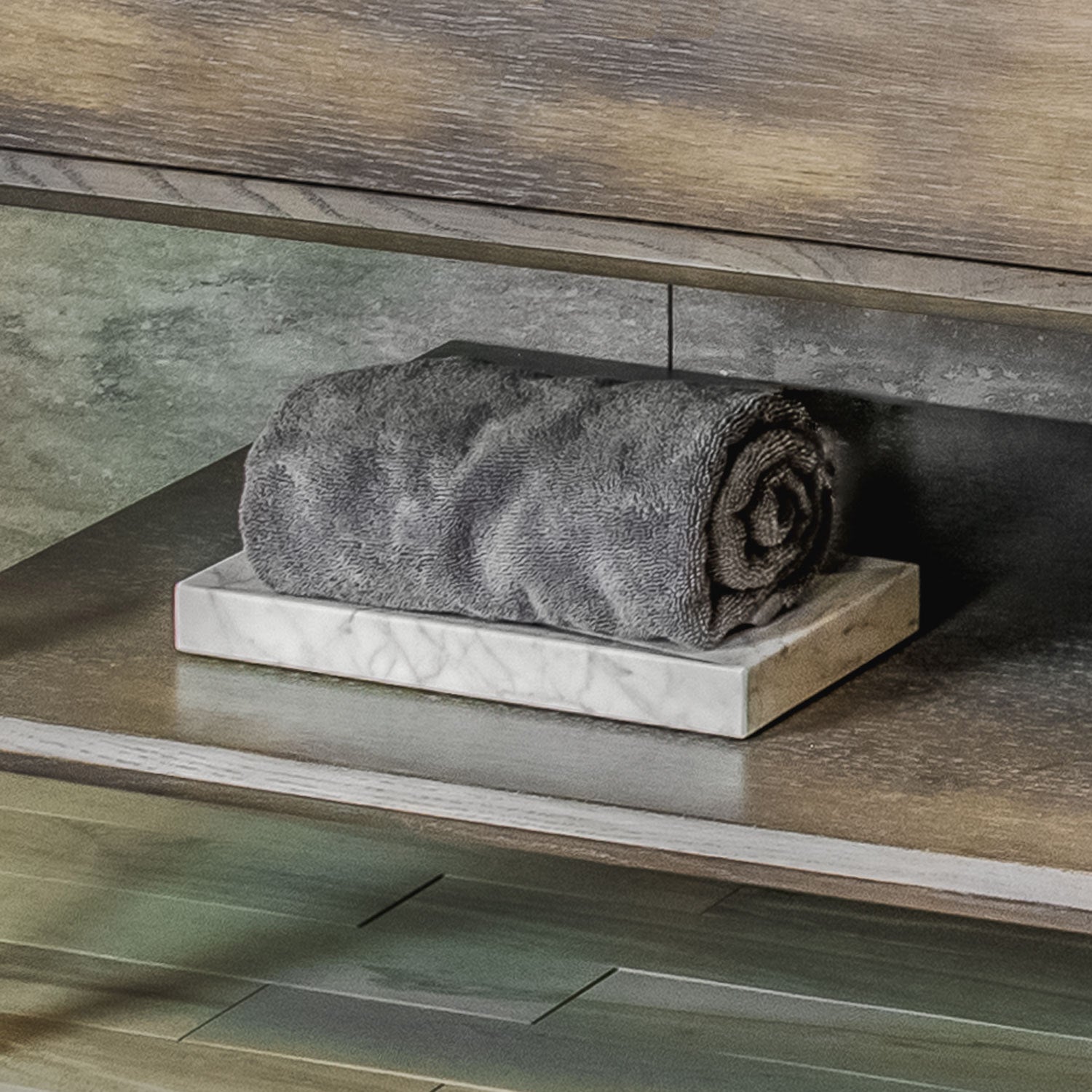 A rectangular Carrara marble bath tray with visible white and gray patterns characteristic of marble stone.