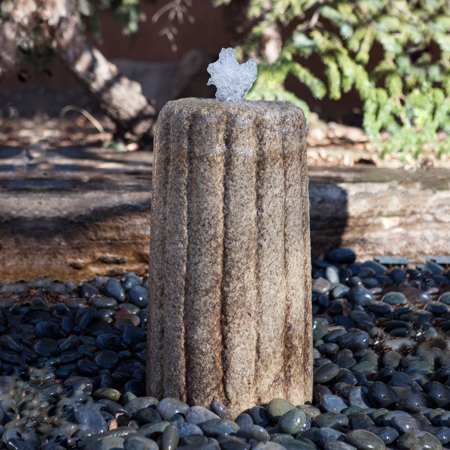 Stone Forest Small Antique Grinding Stone carved from beige granite used as garden fountain