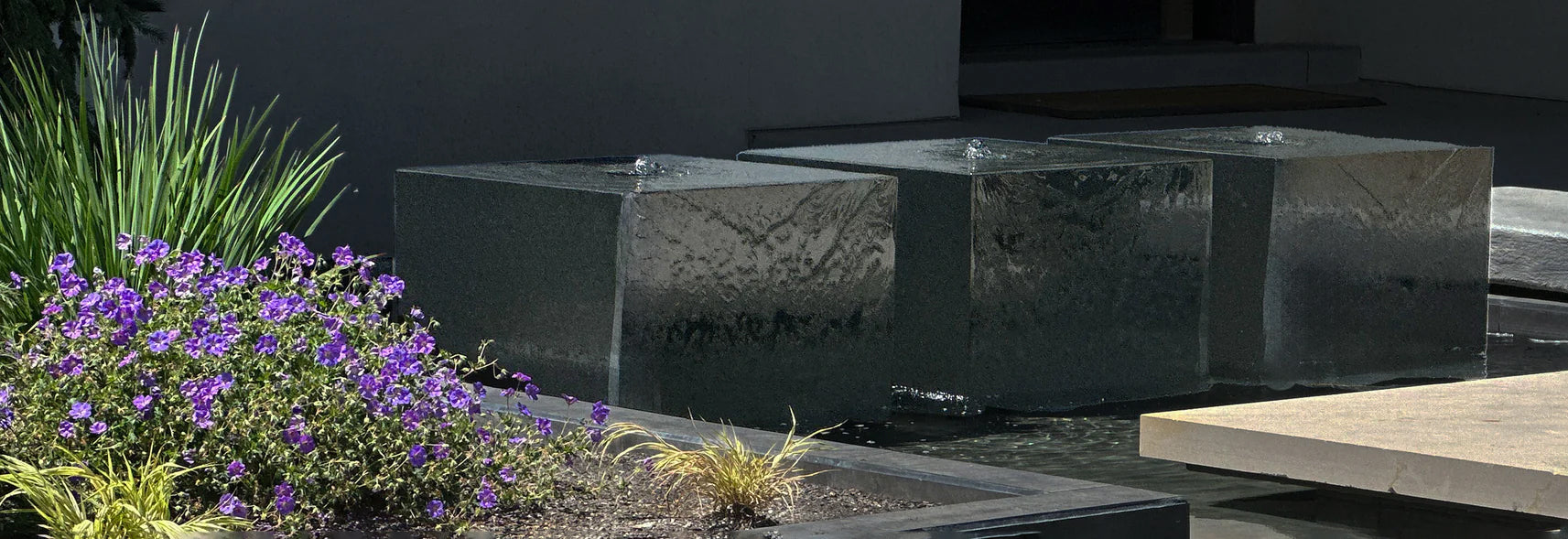 Three custom black granite cube fountains