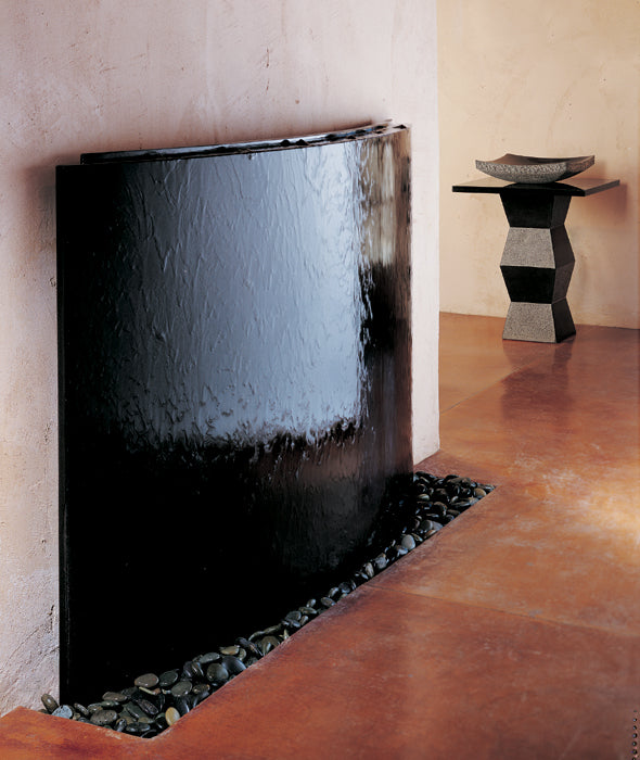 Curved Waterwall with pedestal sink in background