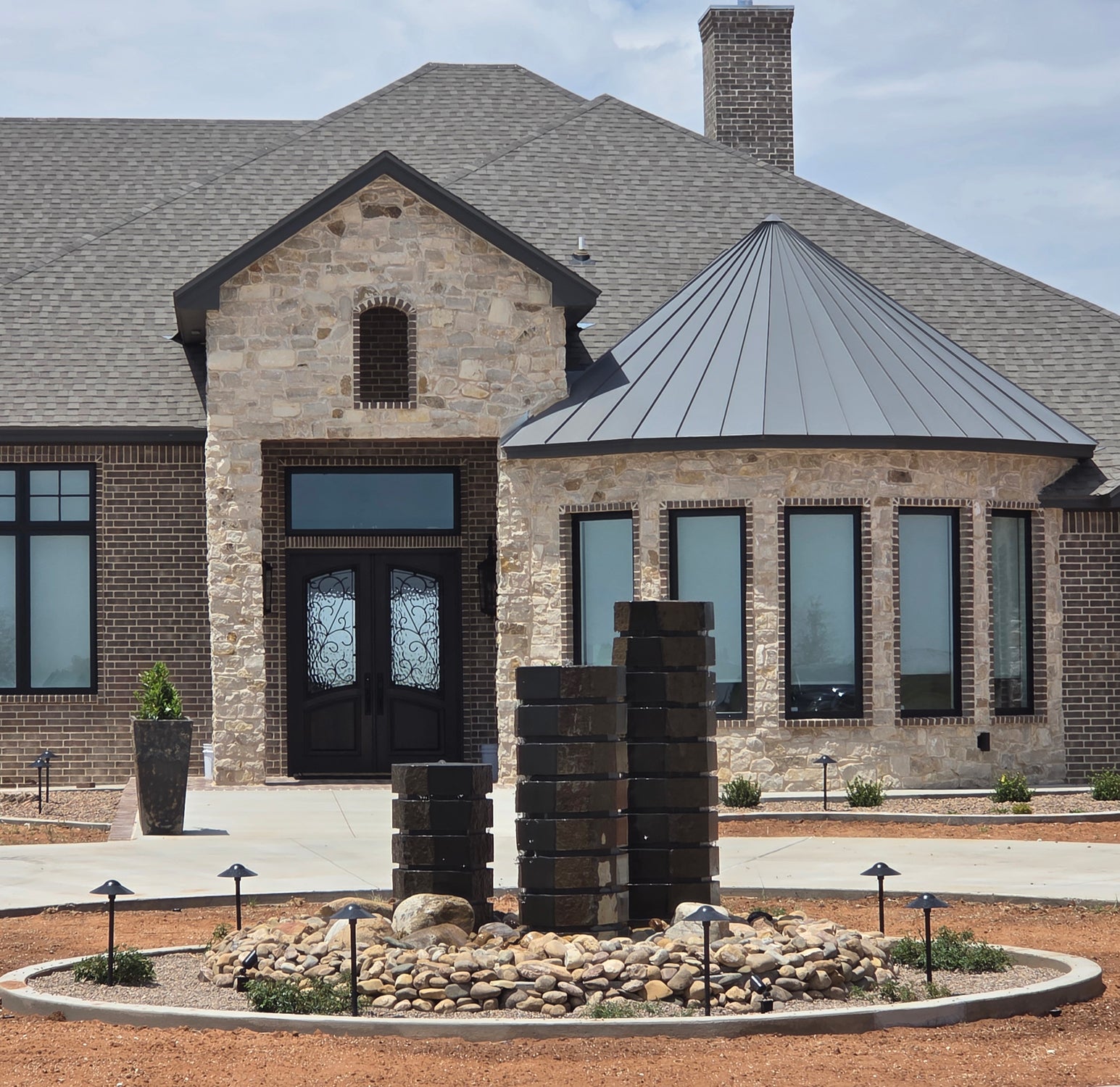 three fountains in front of a house