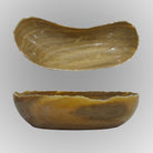 A free-form onyx bowl with a smooth, curved shape, brown and beige