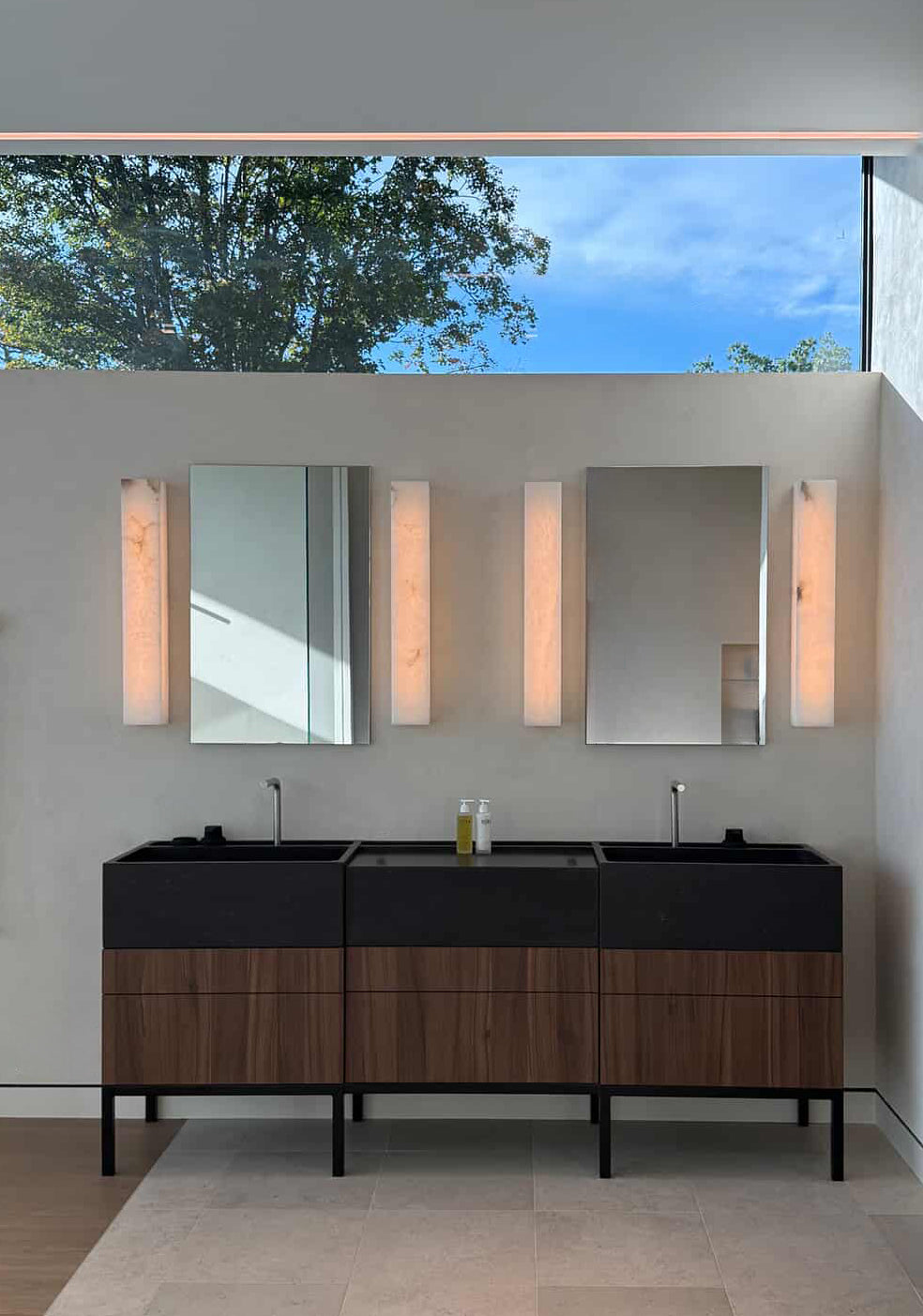 Custom double sink in honed black granite on contemporary vanity