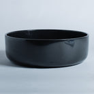  thin-walled vessel sink is carved from a solid block of black granite and finished to a high polish; Drain cover is included.