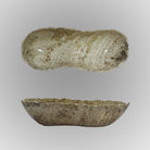 A free-form onyx bowl with a smooth, curved shape against a gray background.