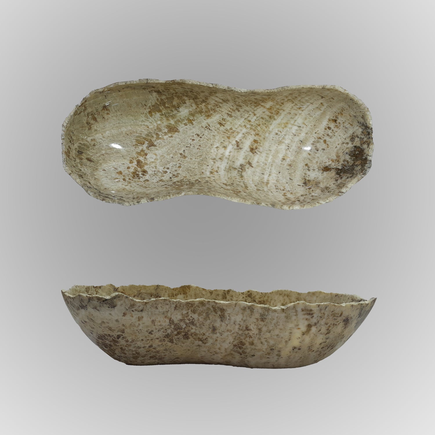 A free-form onyx bowl with a smooth, curved shape against a gray background.