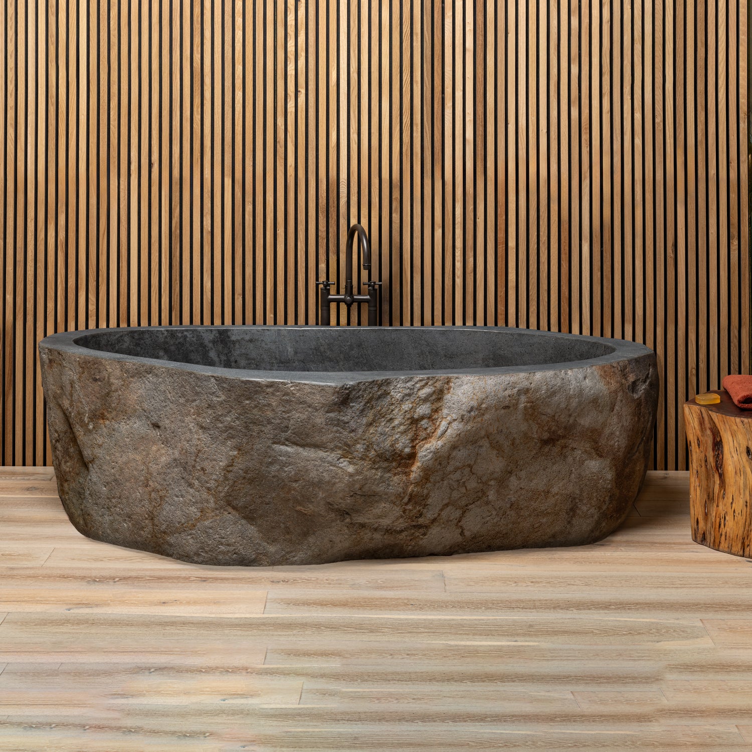 Natural boulder bathtub made of granite boulder. Natural exterior and polished rim and interior.