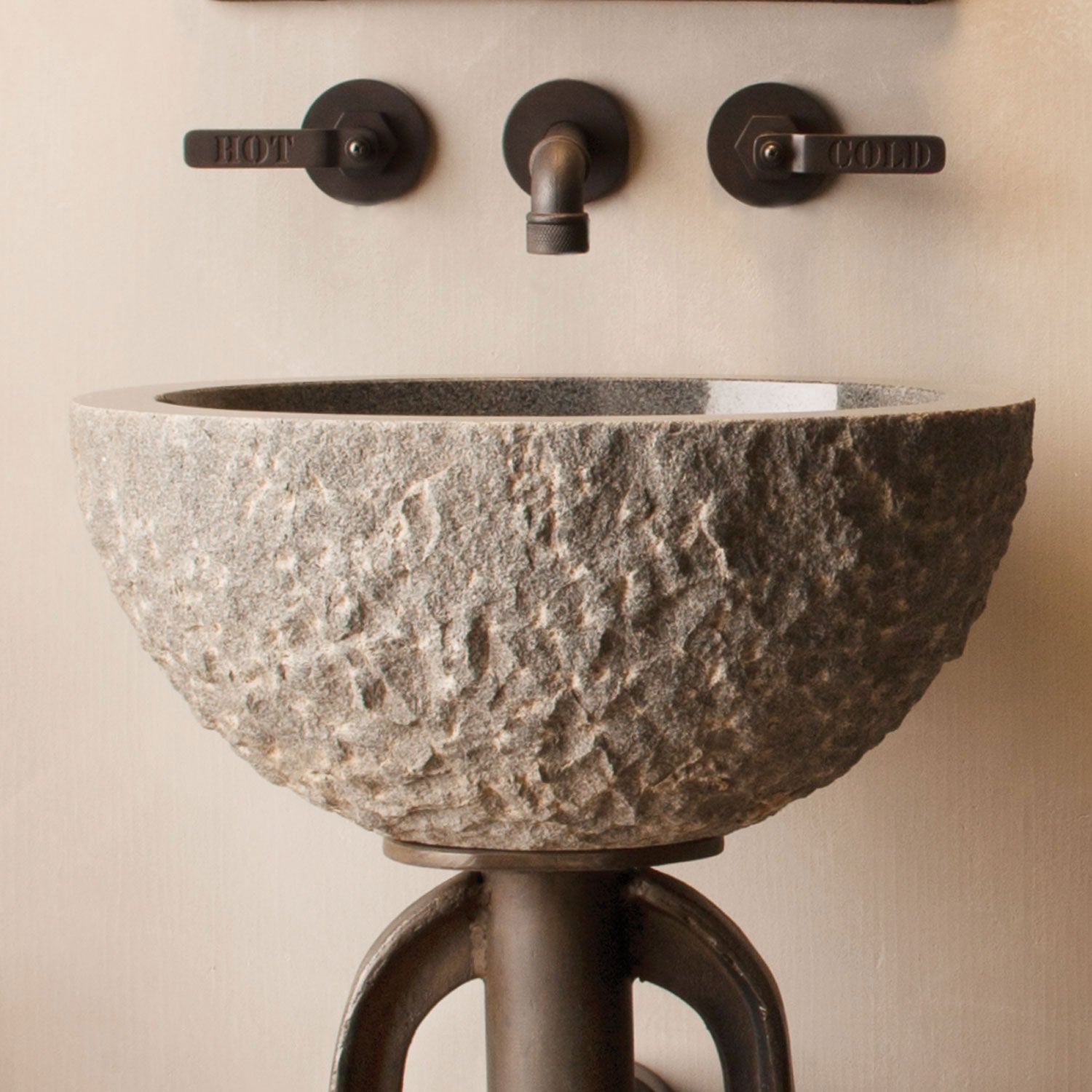 vessel sink with rough chiseled exterior and polished interior in blue-gray granite