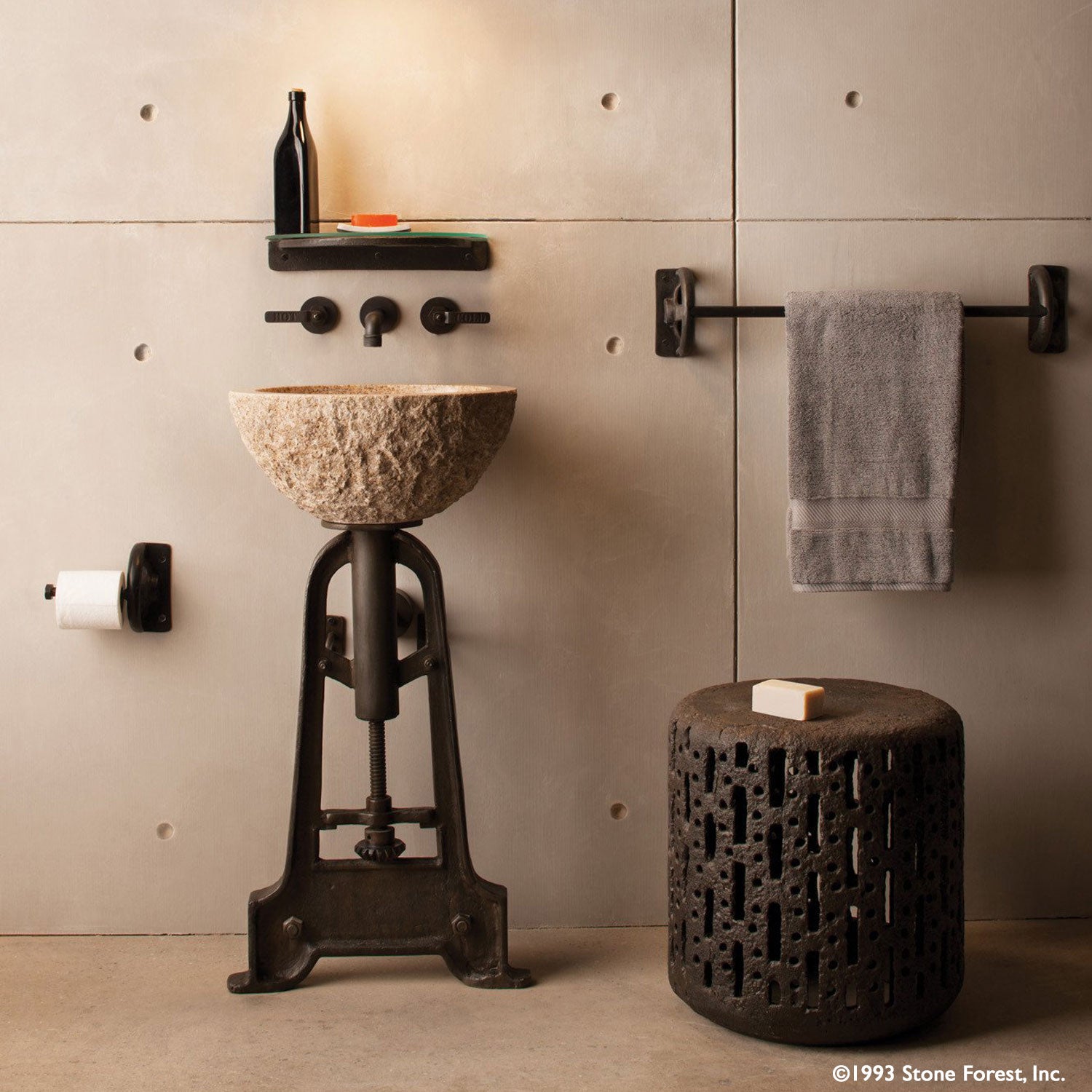Oval Sink is carved from a block of beige granite with a rough chiseled exterior and polished interior.