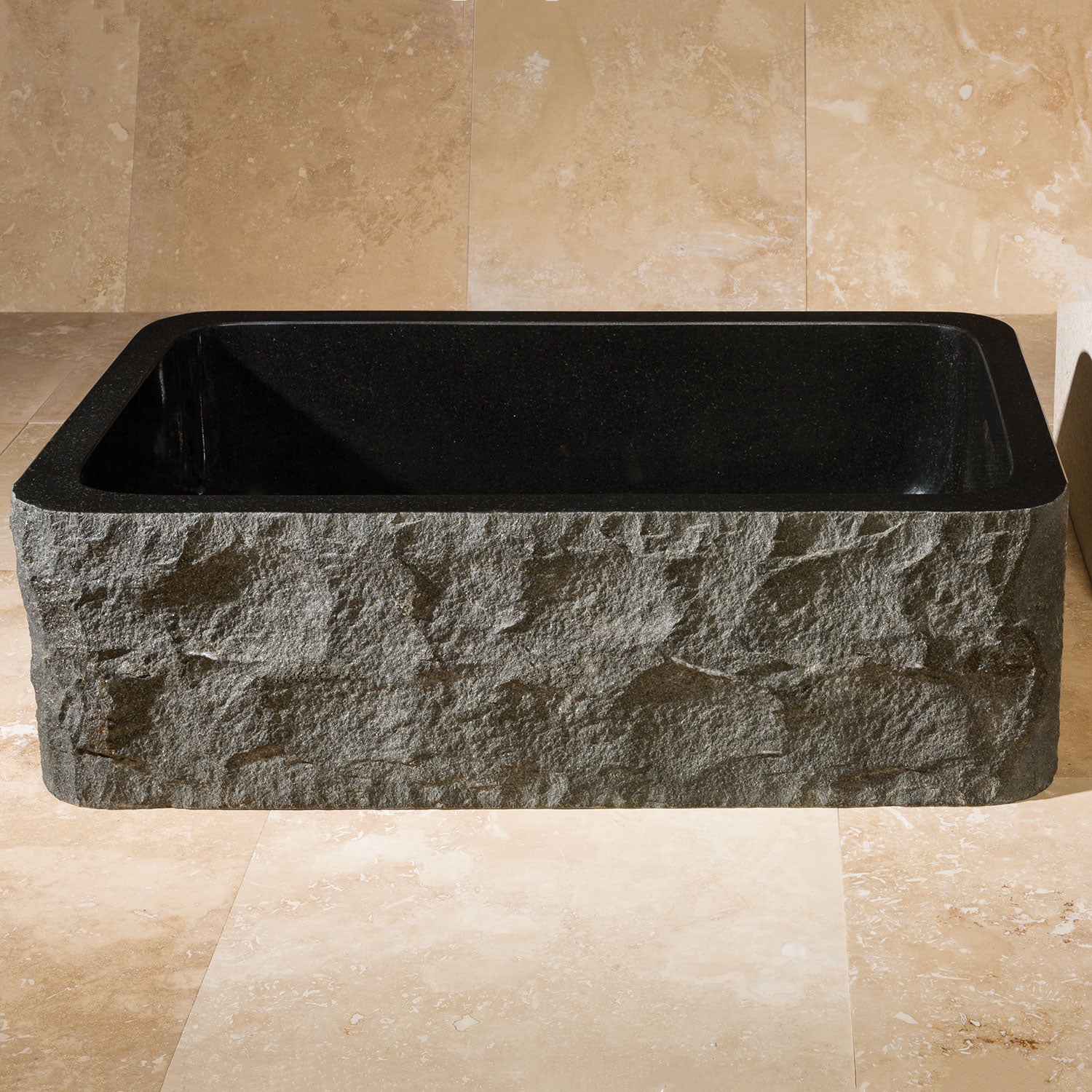 chiseled front farmhouse sink in black granite with polished interior
