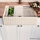 Work station farm house sink with basket weave carved on the apron.
