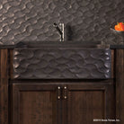 Wave Front Farmhouse sink carved from basalt with a honed finish.