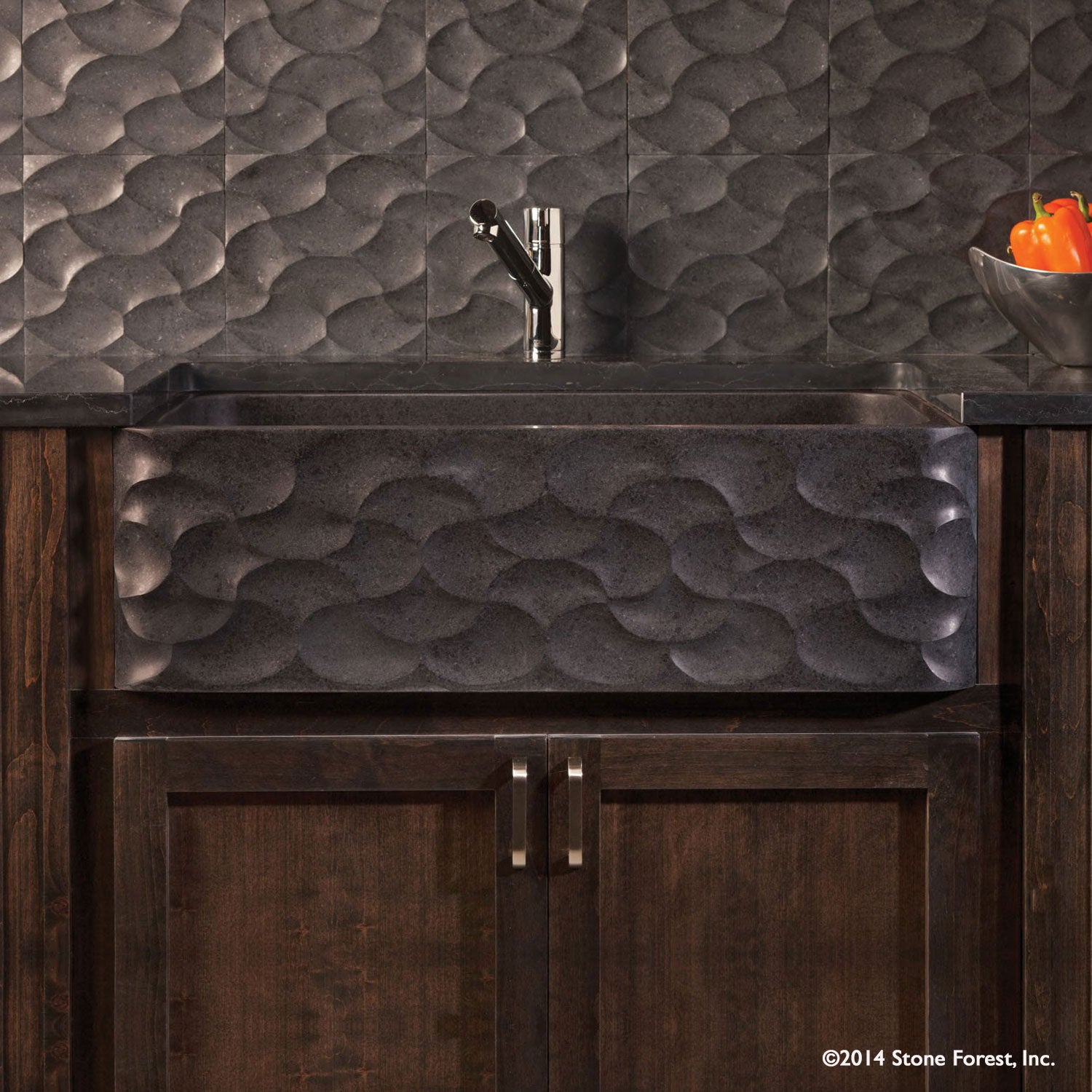 Wave Front Farmhouse sink carved from basalt with a honed finish.