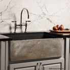Natural Front Farmhouse sink features a polished finish on the interior and the rim of the sink and a natural stone look on the apron.