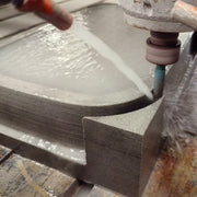 Forma vessel sink being shaped in grigio sandstone