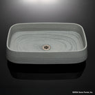 Rectangular gray vessel sink carved from grigio sandstone high angle shot