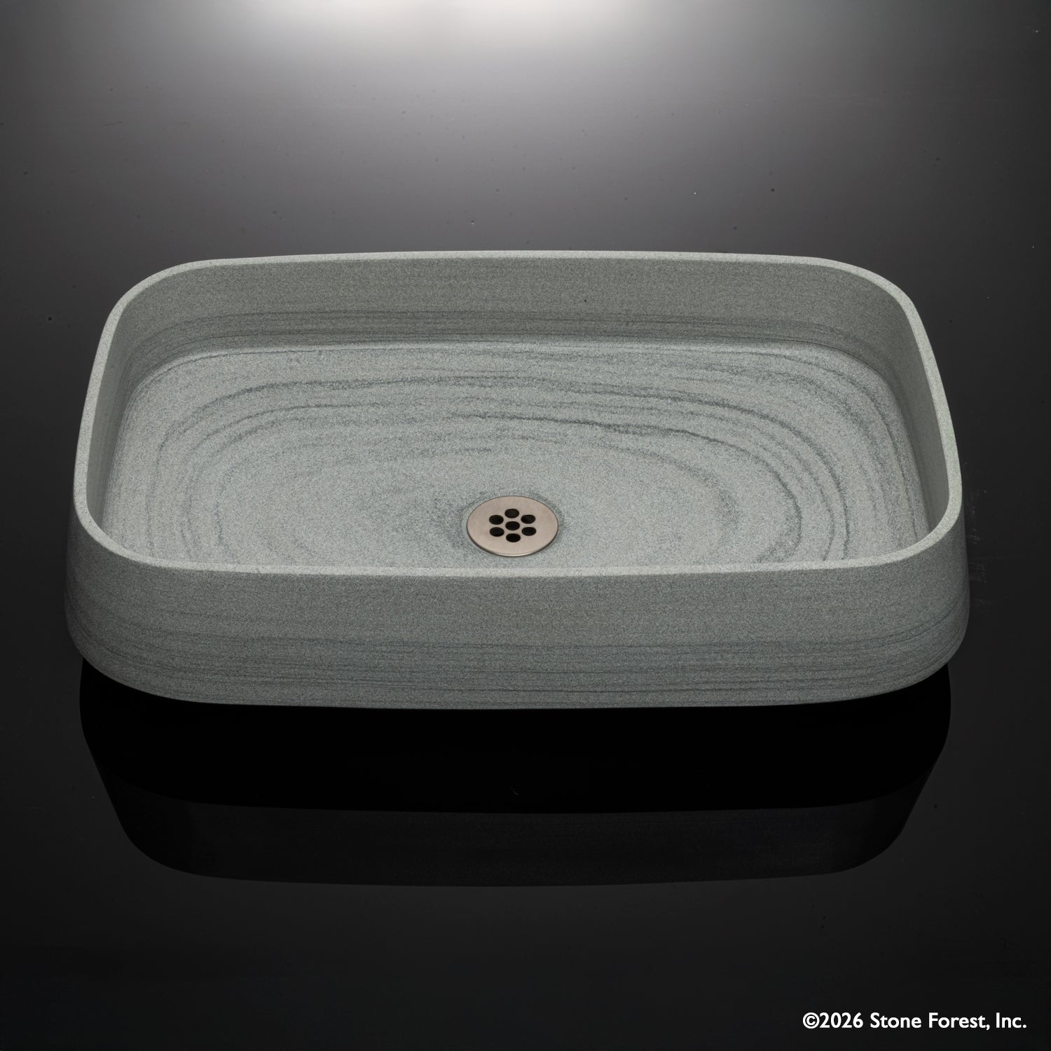 Rectangular gray vessel sink carved from grigio sandstone high angle shot