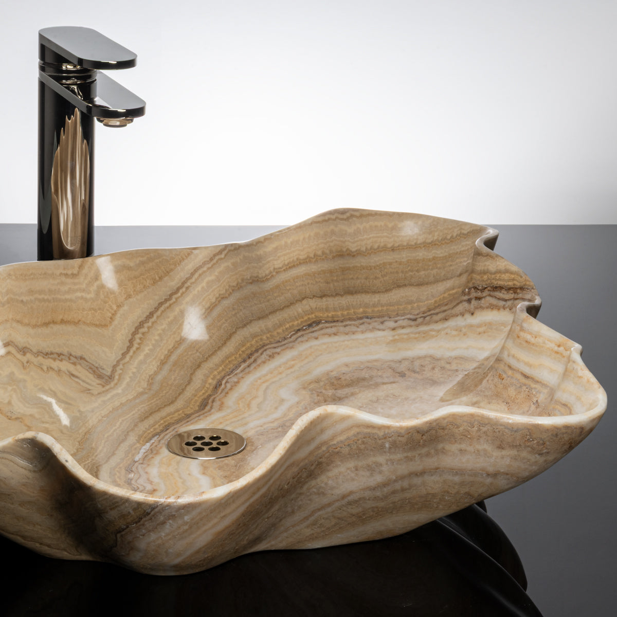 close up of leaf vessel sink in honey onyx