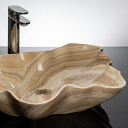 close up of leaf vessel sink in honey onyx