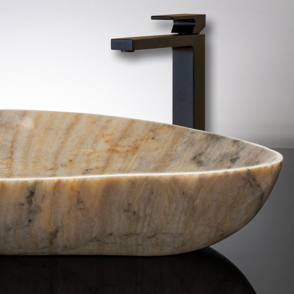 close up of kumo vessel sink in honey onyx