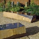 A natural basalt column  bench with the top facet polished to create a smooth surface to sit on.  These one-of-a-kind benchs are available in varying lengths, ranging from 72 to 90 inches.