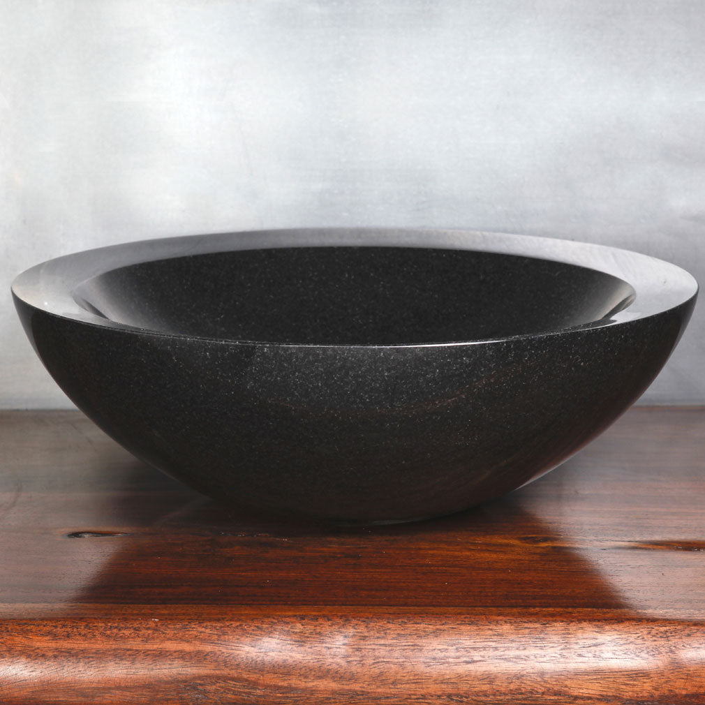 polished beveled vessel sink in black granite