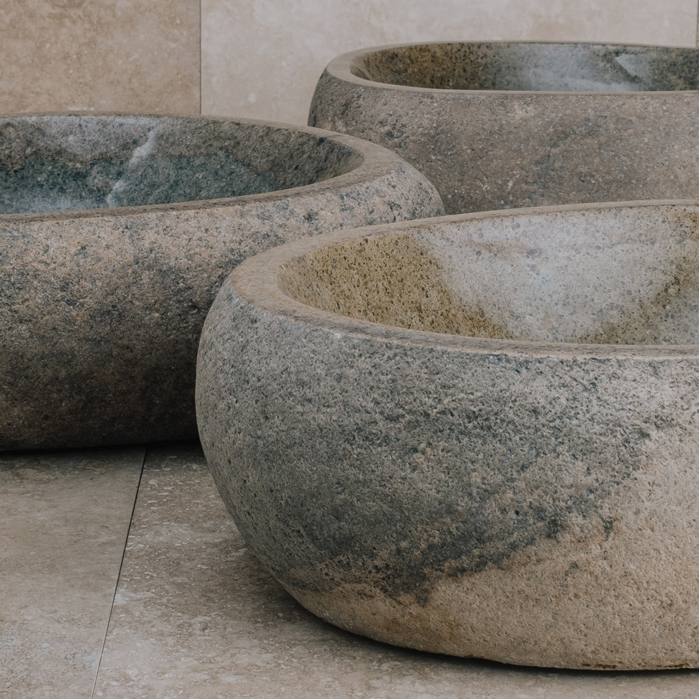 Pebble vessel sink in natural boulder material